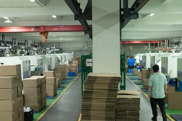 Rows of injection molding presses running automated production cells at Shiny Mold factory in Dongguan